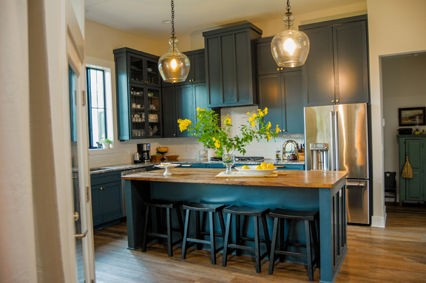 kitchen of custom home built in Woodcreek, Texas but S.B. Thompson Construction. Farmhouse design with blue cabinets, white subway tiles, butcher block counter top, and wood floors.