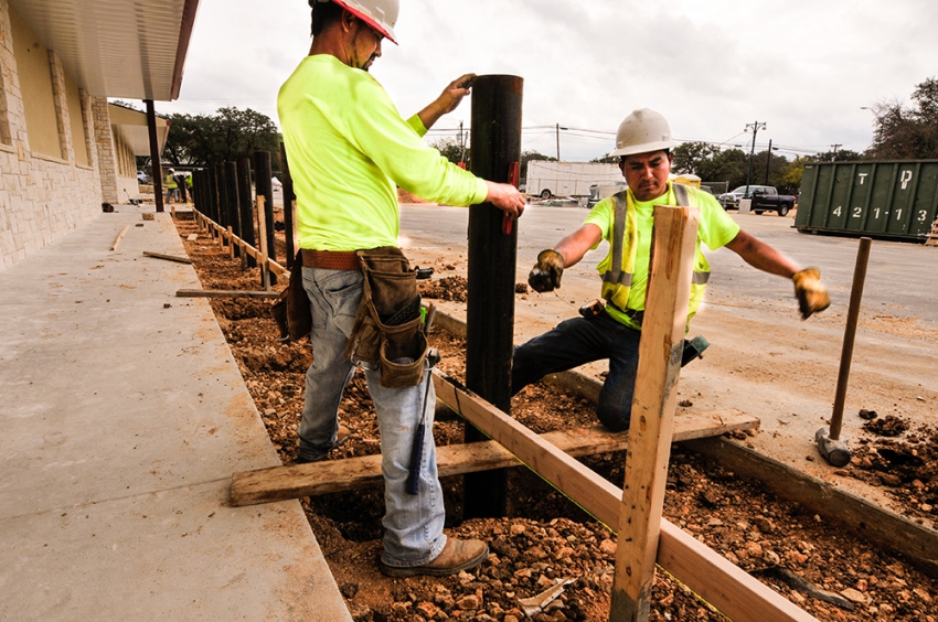 Safety post setting in a commercial parking lot before concrete pour in Wimberley, Texas. Contractors managed by SB Thompson Construction.