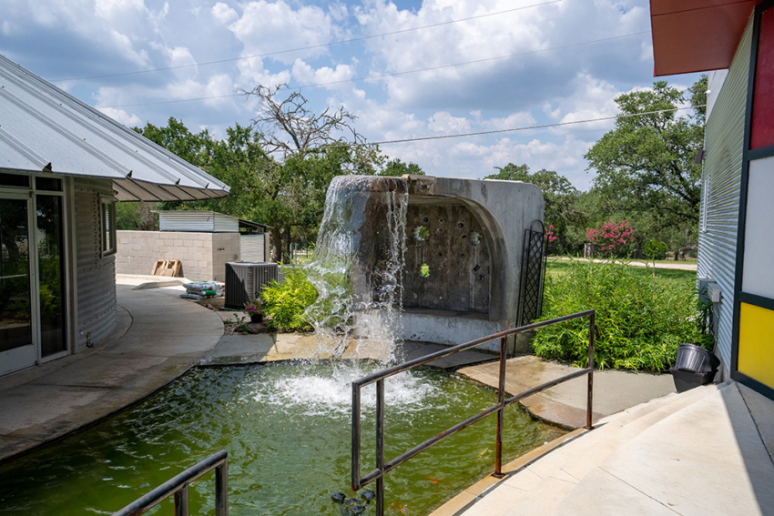 Water fall in front of Silo glass in San Marcos, Texas. Unique colorful commercial building custom built by S.B. Thompson Construction.