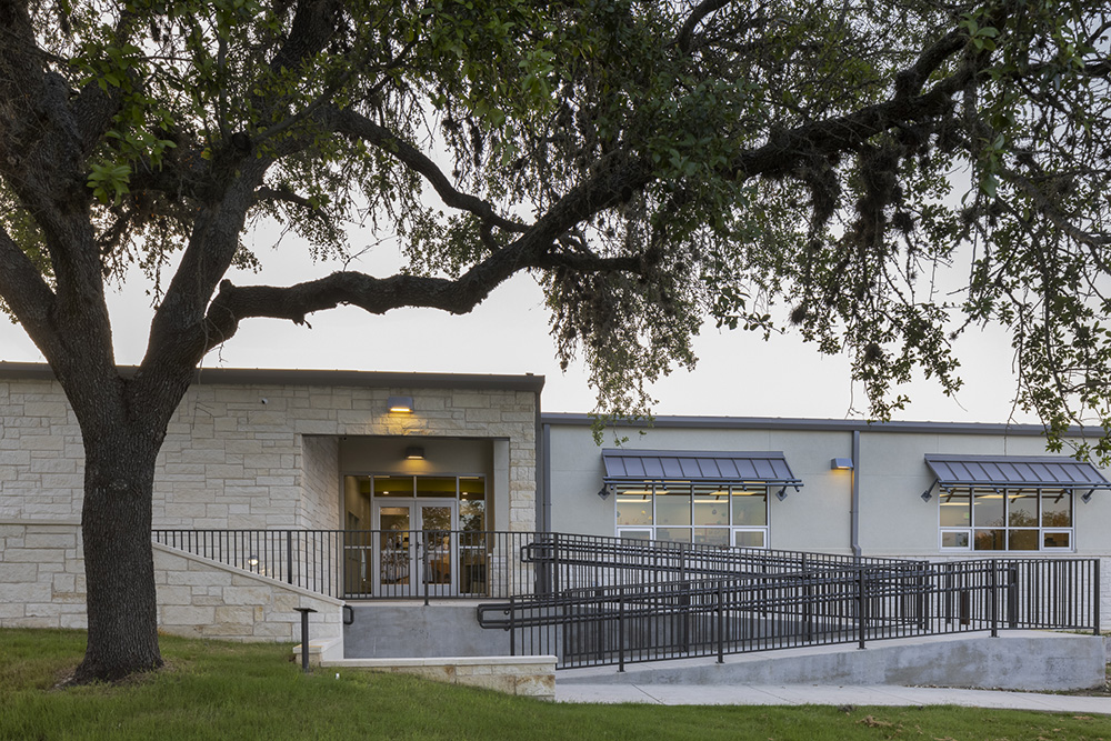 San Marcos Academy expansion and remodel of lower school by S B Thompson Construction. Photo taken at an angle of the side entrance with a ramp and railing for ADA compliance.